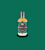 Brass Lion Pearl Jasmine Gin bottle on a deep green background.