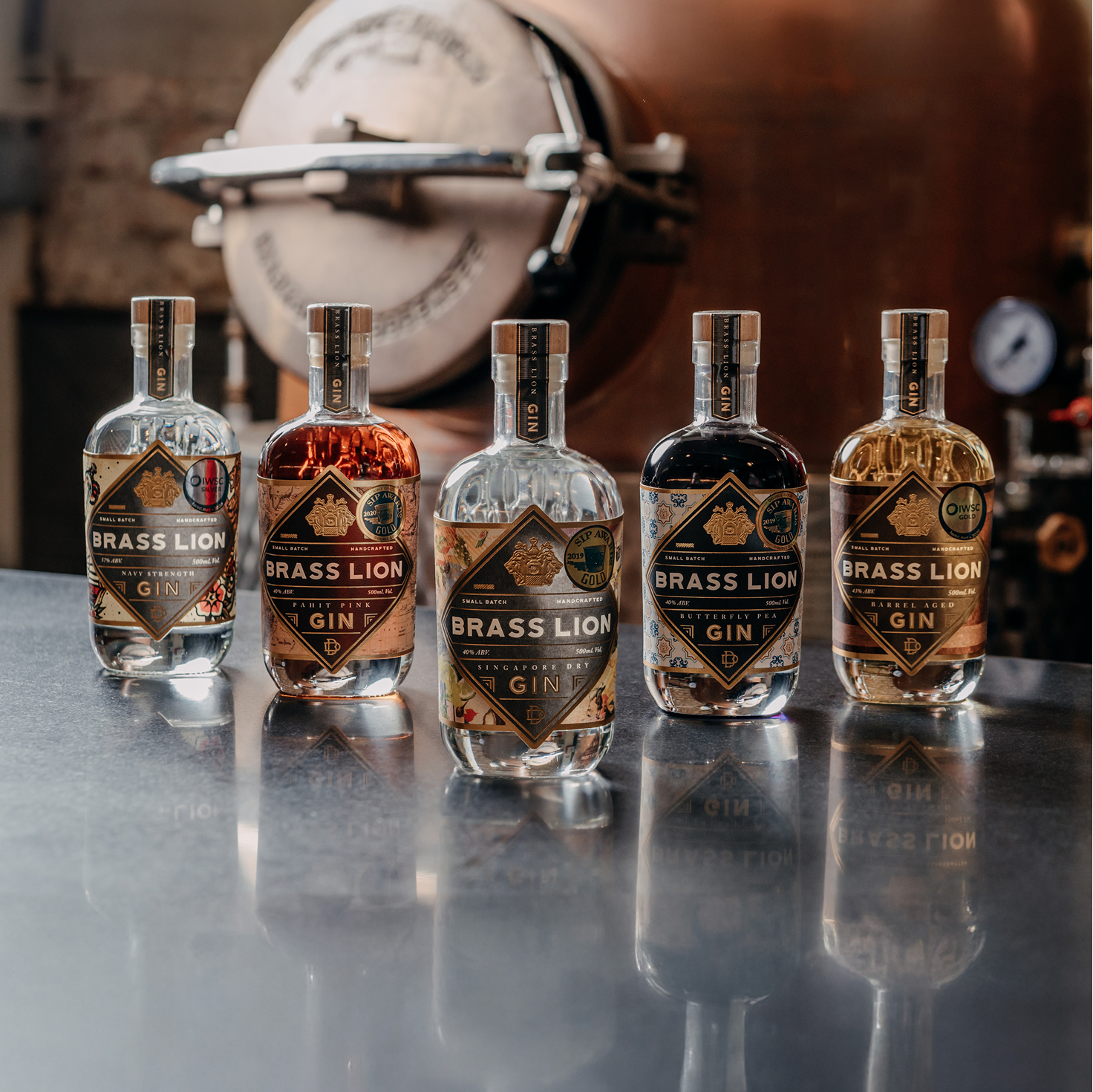 Full range of Brass Lion Gins displayed at the Singapore distillery tour experience including Navy Strength, Pahit Pink, Singapore Dry, Butterfly Pea, and Barrel Aged Gin