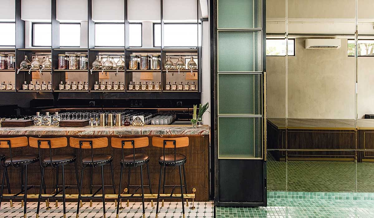 Brass Lion Distillery tasting room with marble bar counter, gin display shelves, and elegant apothecary decor as featured on The Peak Singapore